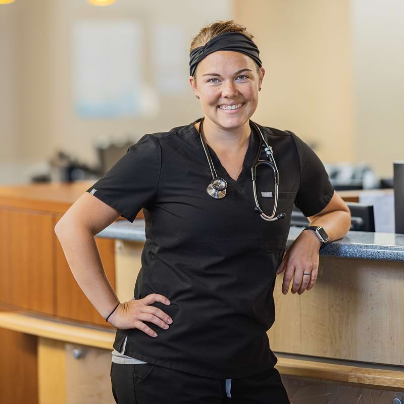 Medical worker leaning against desk