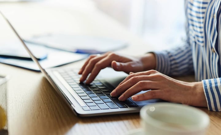 close-up-of-hands-typing-on-laptop