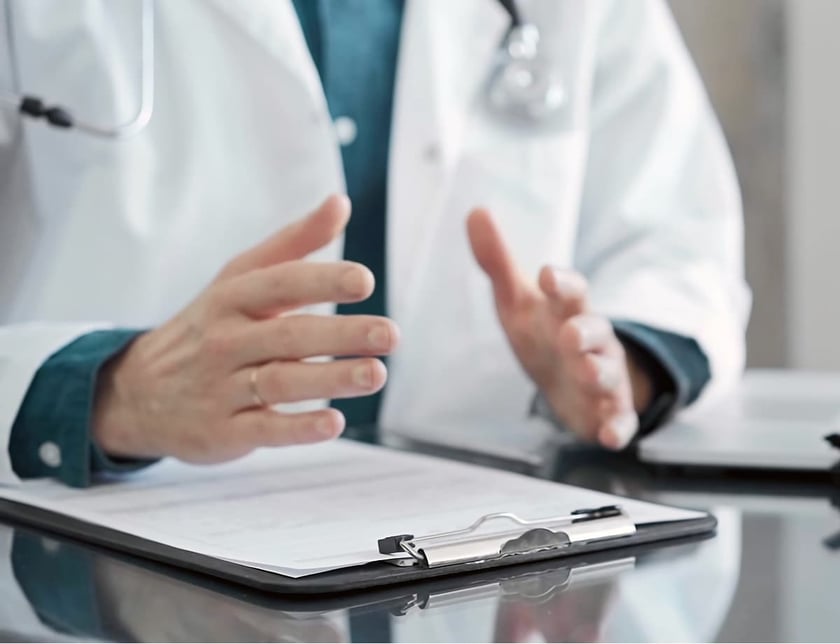 doctor explains a diagnosis in a modern medical office, close up.