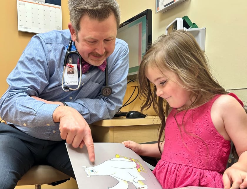 dr_bratney_reading_a_book_with_a_child