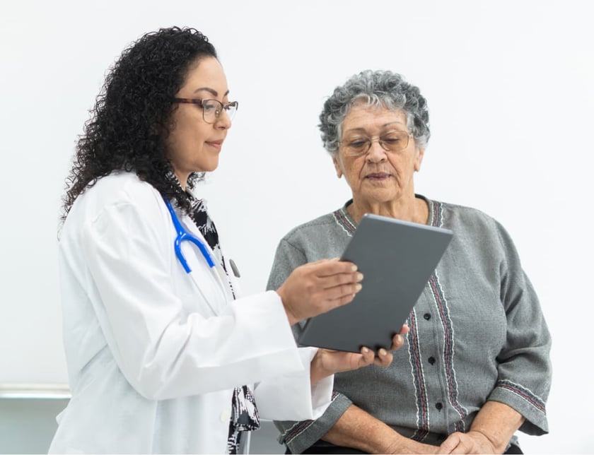 elderly_woman_looking_at_tablet_with_doctor
