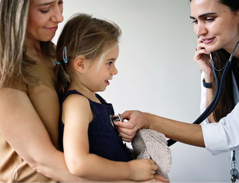 Doctor using a stethoscope to listen to a child's heart