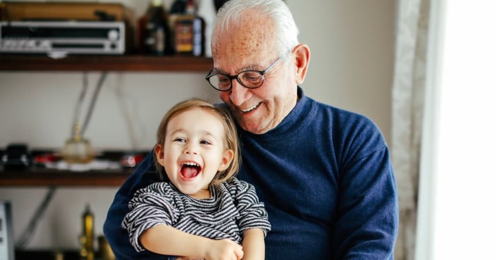 An older man with his granddaughter