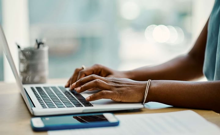 Woman hands typing on laptop