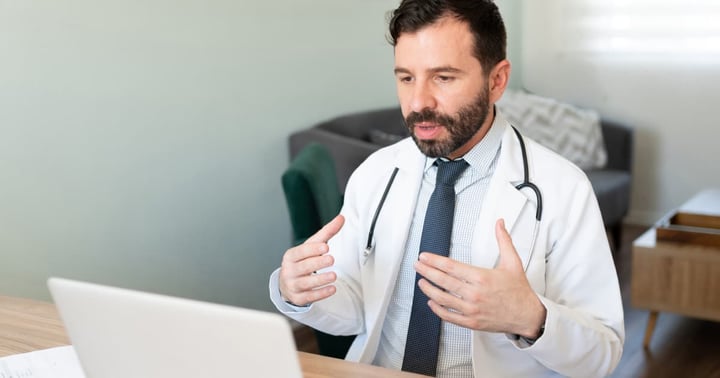Portrait of a virtual doctor giving medical advice to a patient during a video call 