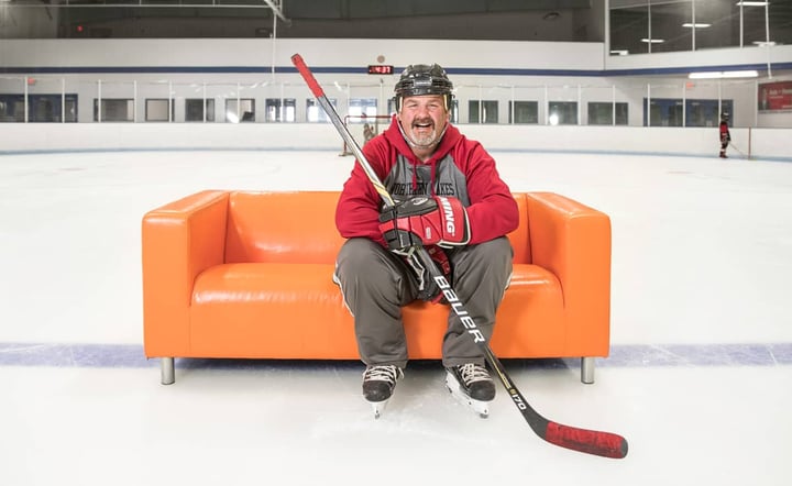 hockey-player-laughing-orange-couch-ice-rink
