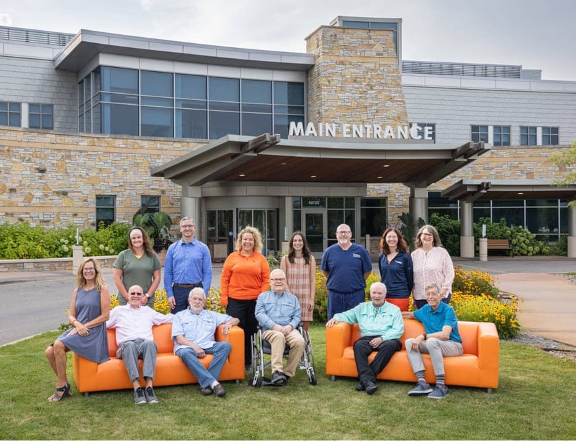 lakewood-health-system-staff-group-photo-orange-couches-main-entrance