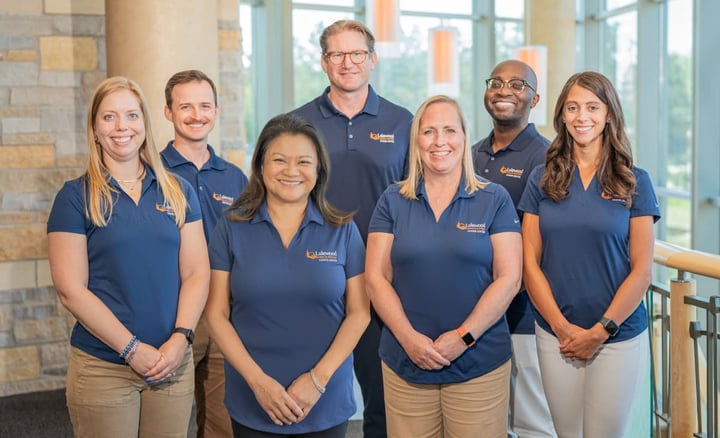 lakewood-health-system-staff-team-photo-in-branded-polos-in-modern-facility-1