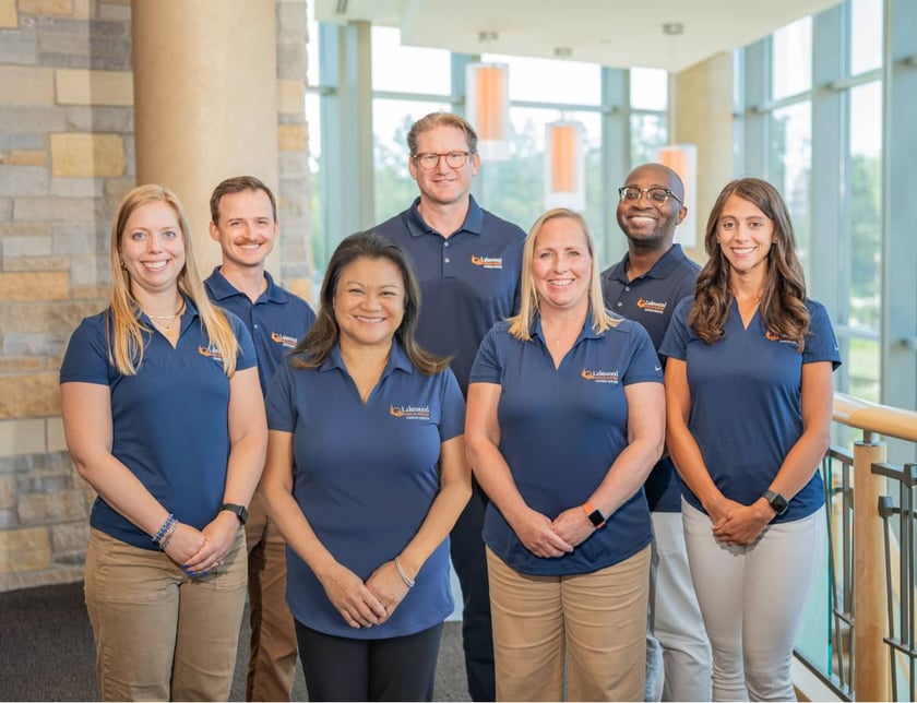 lakewood-health-system-staff-team-photo-in-branded-polos-in-modern-facility