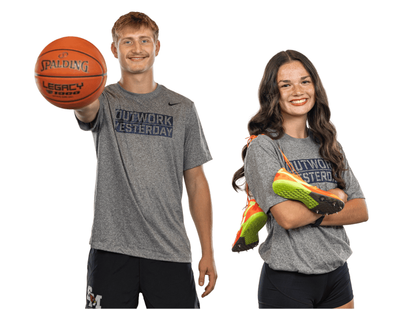 male-and-female-teen-athletes-posing-with-basketball-and-cleats