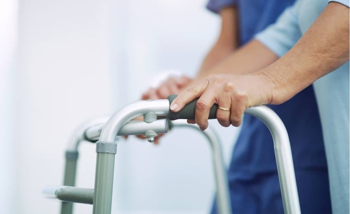 nurse-assists-patient-using-walker-during-rehabilitation