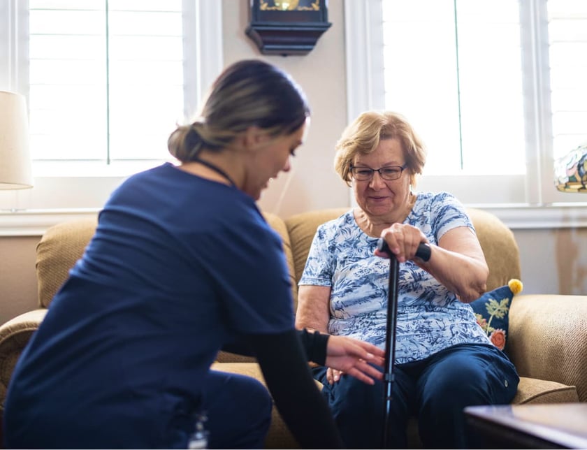 An elderly woman has a home visit for her nurse for some home health care.