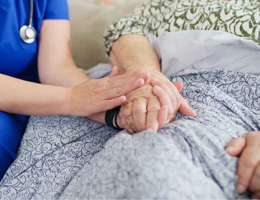 nurse_holding_hand_of_elderly_woman