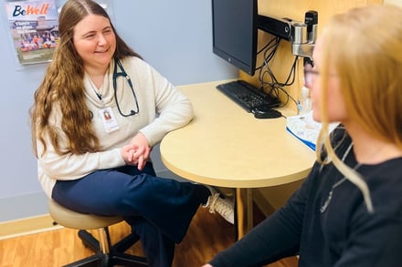 physician_and_young_woman_sitting_in_office