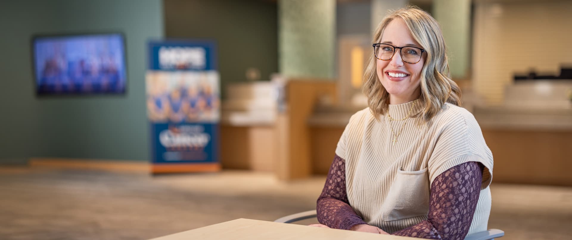 smiling-woman-wearing-glasses-modern-office-lobby
