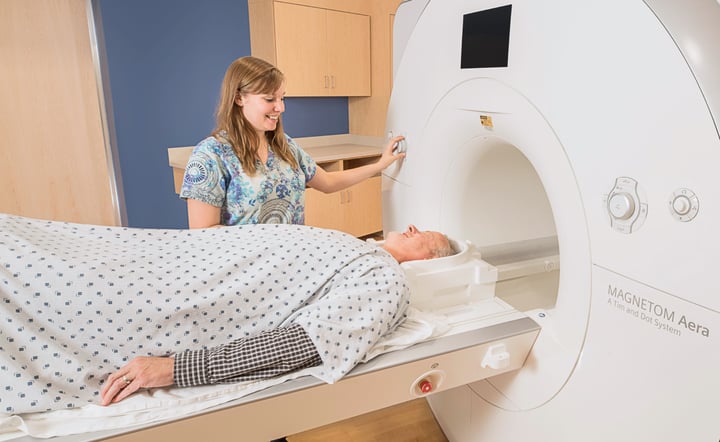 technologist-prepares-patient-for-mri-scan-in-imaging-suite