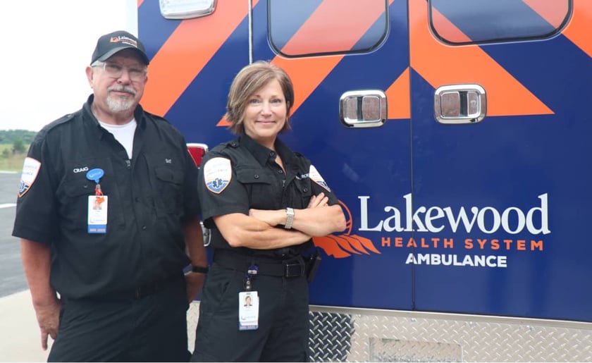 two-ems-staff-smile-in-front-of-lakewood-health-system-ambulance