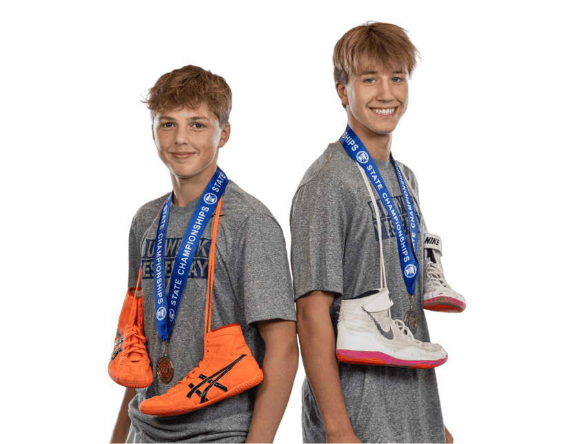 two-teen-athletes-wearing-state-championship-medals-holding-shoes