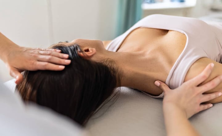 woman-receiving-physical-therapy-massage-treatment-table
